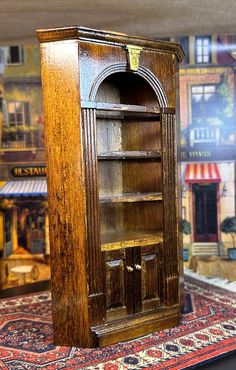 an old wooden bookcase sitting on top of a rug