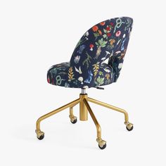 an office chair with floral fabric and gold wheels