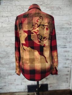 a red and black plaid shirt with a deer on it