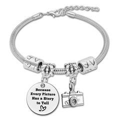 a charm bracelet with a camera and the words because every picture has a story to tell