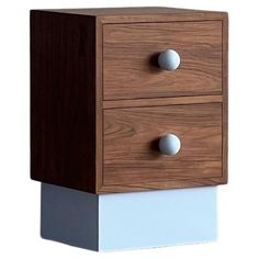 two drawers with white and brown handles on each drawer, one has three balls in it