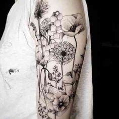 a black and white flower tattoo on the right arm