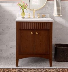 a bathroom with a sink, mirror and rug