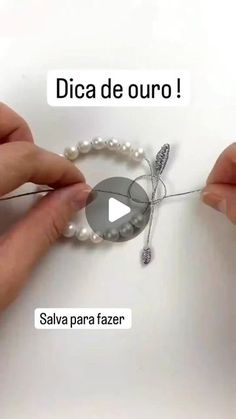 someone is making a bracelet with pearls and beads