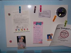 a bulletin board with pictures, notes and magnets attached to it's side