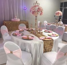 a banquet table set up with pink and gold decorations