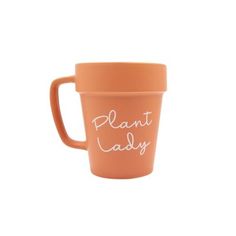 an orange cup with the words plant lady written in white ink on it, sitting against a white background