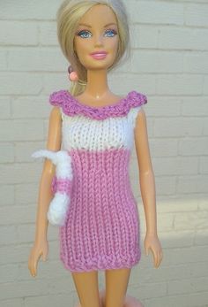 a doll wearing a pink and white knitted dress