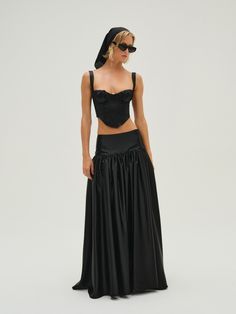 Make an unforgettable entrance this season in the Nelly black maxi skirt, featuring a tall flat yoke, drop waist, and full gathered heavyweight satin skirt. Pair this long skirt with the Nelly Top for a co-ord set. Co Ord Sets Skirt, Skirt With Yoke, Yoke Skirt, Fashion Mood Boards, Corset Top Black, Full Gathered Skirt, Satin Maxi Skirt, Maxi Skirt Set, Black Maxi Skirt