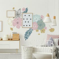 a bedroom with floral wall decals on the walls and dressers in front of it