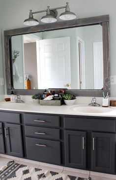 a bathroom vanity with a large mirror above it