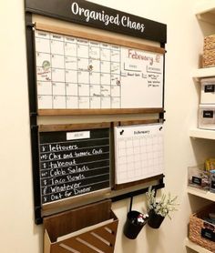 a dry erase board mounted to the side of a wall next to shelves with baskets on it