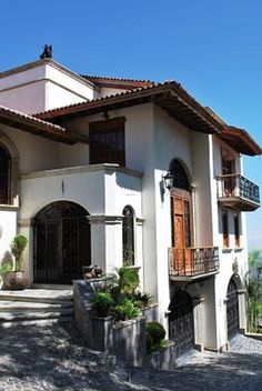 a large white house with lots of windows and balconies