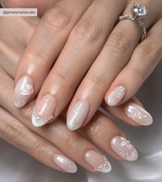 a woman's hands with french manies and white nail polish on their nails