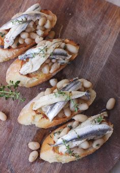 fish and white beans on bread with herbs