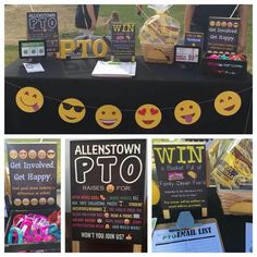 the table is set up with signs and other items for sale at an outdoor event