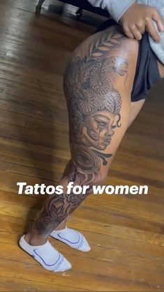 a woman's leg with tattoos on it