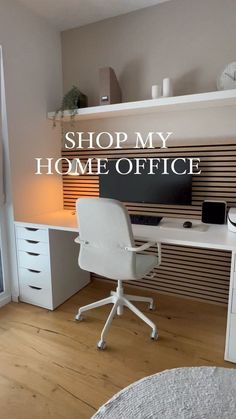 a white desk sitting in front of a computer on top of a wooden floor next to a window