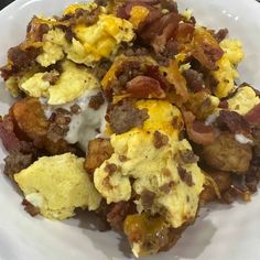 a white plate topped with eggs, bacon and hashbrowns on top of it