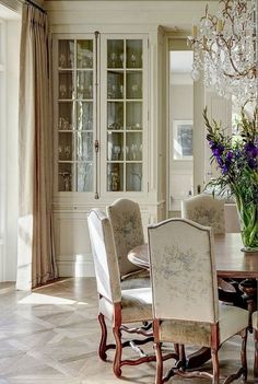 a dining room table with chairs and a chandelier