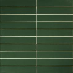 a green tile wall with horizontal lines in the center and bottom, as well as vertical white lines on each side