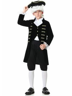 a young boy wearing a black and white outfit with a large hat on his head