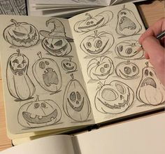 an open book with drawings of halloween pumpkins and jack - o'- lantern faces