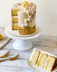 two slices of cake sitting on top of white plates next to each other with lemons