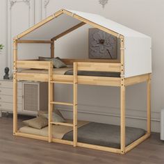 a wooden bunk bed with a white tent on top