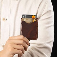 This wallet features a sleek, minimalist design with 𝗻𝗼 𝗯𝗿𝗮𝗻𝗱 𝗹𝗼𝗴𝗼. This card holder is 𝗽𝗲𝗿𝗳𝗲𝗰𝘁 𝗳𝗼𝗿 𝗶𝗻𝗱𝗶𝘃𝗶𝗱𝘂𝗮𝗹𝘀 𝘄𝗵𝗼 𝗽𝗿𝗲𝗳𝗲𝗿 𝗻𝗼𝘁 𝘁𝗼 𝗰𝗮𝗿𝗿𝘆 𝗮𝗻𝘆𝘁𝗵𝗶𝗻𝗴 𝗵𝗲𝗮𝘃𝘆 𝗼𝗿 𝗯𝘂𝗹𝗸𝘆 𝗶𝗻 𝘁𝗵𝗲𝗶𝗿 𝗽𝗼𝗰𝗸𝗲𝘁𝘀. This item is not made by a sewing machine; it is 𝗰𝗼𝗺𝗽𝗹𝗲𝘁𝗲𝗹𝘆 𝗵𝗮𝗻𝗱𝗰𝗿𝗮𝗳𝘁𝗲𝗱. It is a 𝗵𝗮𝗻𝗱-𝘀𝘁𝗶𝘁𝗰𝗵𝗲𝗱, high-quality vegetable-tanned leather card holder, made to order to be a unique gift for any occasion, a bir Rfid Blocking Wallet For Everyday Use, Rfid Blocking Solid Wallet For Everyday Use, Solid Color Wallet With Rfid Blocking For Everyday Use, Minimalist Trifold Wallet With Card Slots For Everyday, Minimalist Rectangular Card Holder For Everyday Use, Daily Use Bifold Card Holder With Cell Phone Pocket, Minimalist Rfid Blocking Card Holder For Everyday, Solid Color Rfid Blocking Wallet For Everyday Use, Minimalist Bifold Card Holder With Slots