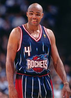 the basketball player is wearing a blue uniform with red stripes on it's chest