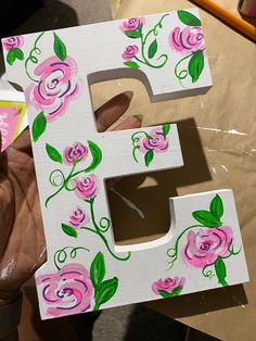 the letter e is painted with pink flowers