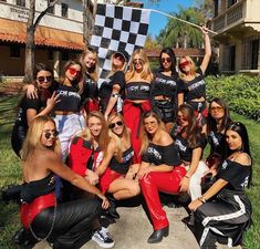 a group of women in costumes posing for a photo