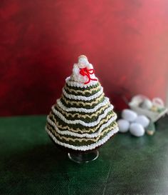 a crocheted christmas tree sitting on top of a table