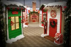 an assortment of christmas decorations and decor in a store front display area with snow on the ground