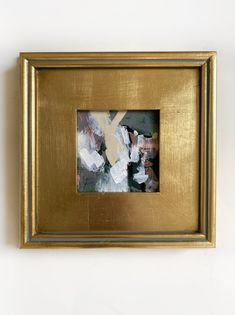 a gold frame with an abstract painting in it