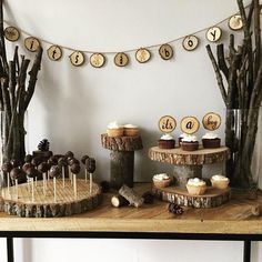 a table with cupcakes and desserts on it in front of some trees