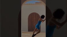 a woman in a blue dress is dancing