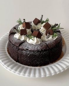 a chocolate cake topped with whipped cream and sprinkles