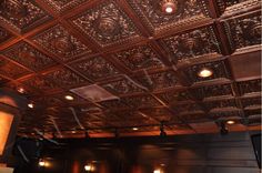 an ornate ceiling in a theater with lights on the sides and dark wood paneling