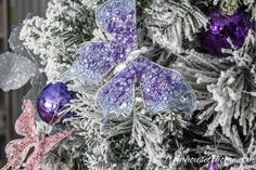 a christmas tree with purple and silver decorations