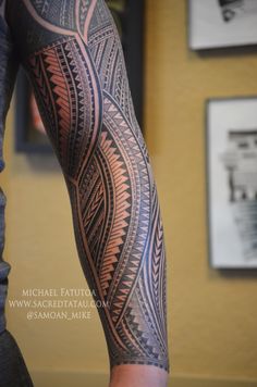 a man's arm with an intricate tattoo design on the forearm and leg area