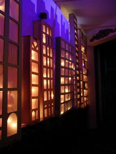 an image of a building that is lit up at night with candles in the windows