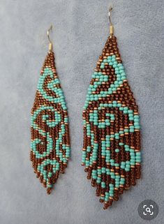 two pairs of beaded earrings with turquoise and brown beads on the bottom one ear