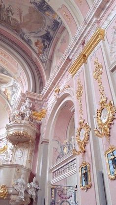 an ornately decorated room with gold and white decorations on the walls, along with paintings