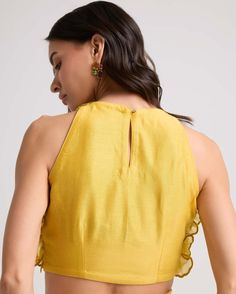 Radiate in this yellow chanderi top, featuring a shaded dahlia motif crafted with intricate 3d applique. This piece captures attention with its stunning detail, offering elegance and flair to any ensemble. Elegant Yellow Blouse Piece With Dori Work, Elegant Yellow Padded Blouse, Elegant Festive Tops With Ruffles, Elegant Yellow Cotton Silk Blouse Piece, Elegant Festive Tops With Dori Work, Elegant Cutdana Tops, Festive Yellow Top With Floral Embroidery, Festive Yellow Floral Embroidered Top, Festive Yellow Floral Embroidery Tops