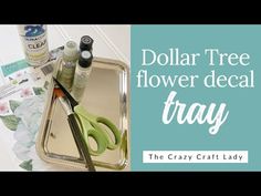 dollar tree flower decal tray with scissors, glue and other crafting supplies on it