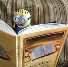 a minion reading a book with the caption, wow look at what the bible teaches live forever on a paradise earth