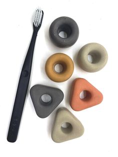 five different shapes of doughnuts and a toothbrush