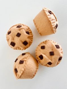 three chocolate chip cookies sitting next to each other on top of a white countertop